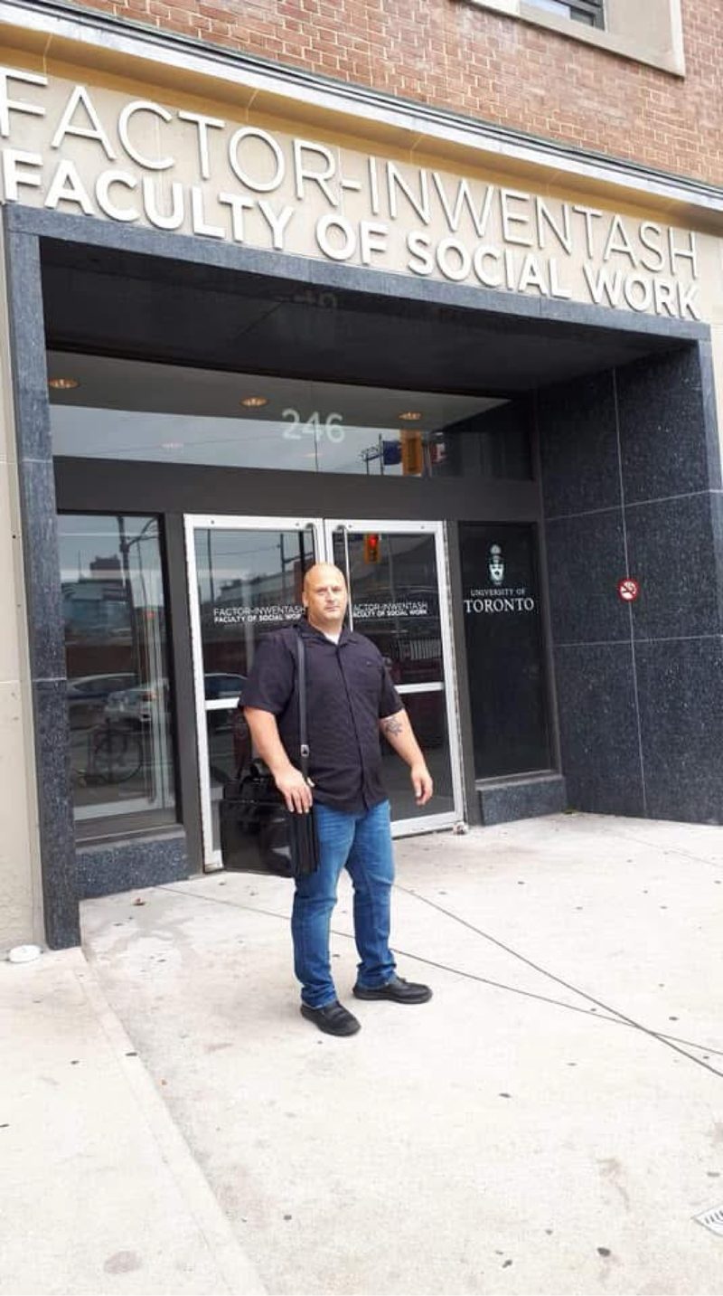 Jason W. George outside the Factor-Inwentash Faculty of Social Work, University of Toronto